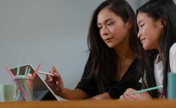 Two women looking at a tablet